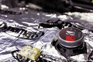 Apply Dynamat sound deadening material to cover as much of the inner side of the door skin as possible. This will help to reduce sound vibrations and outside noise from the passenger cabin