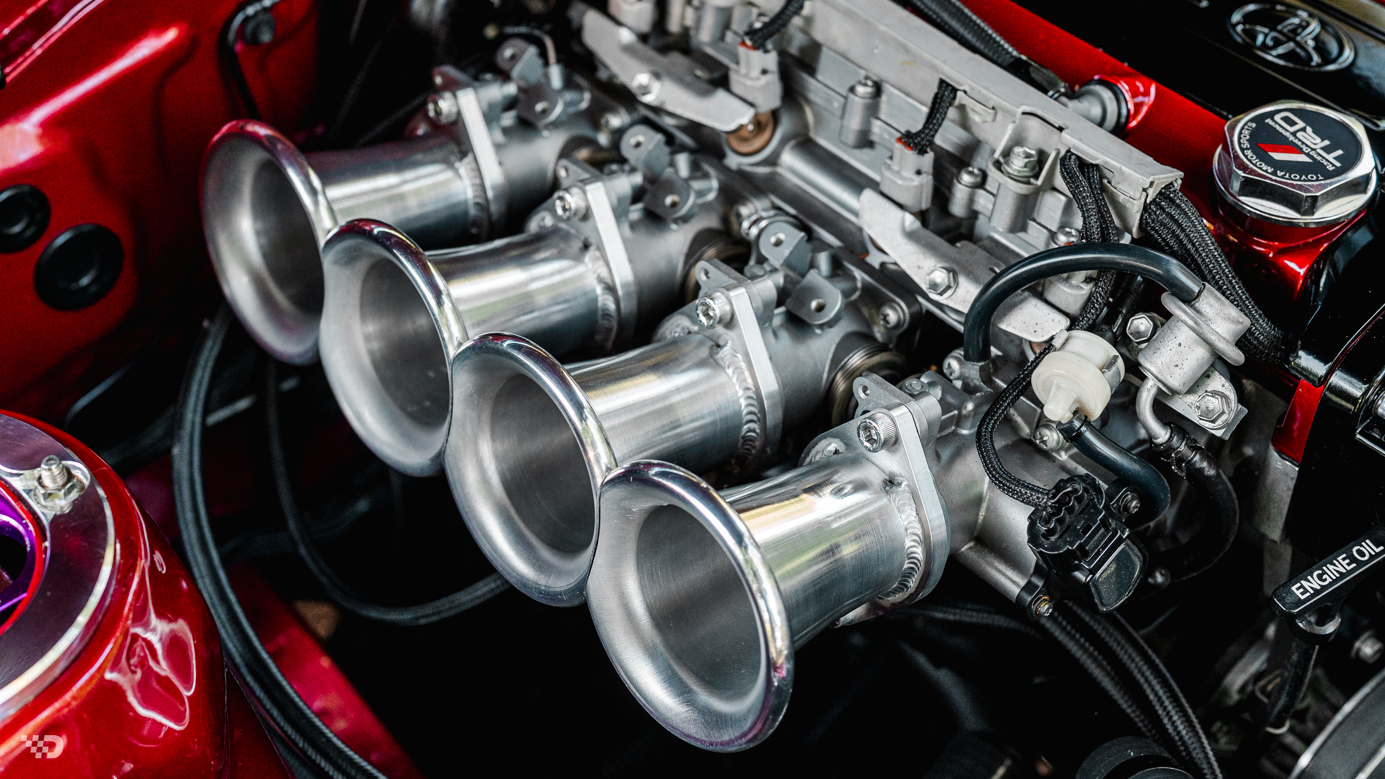 Close-up of polished individual throttle bodies on 4AGE Blacktop 20V engine.