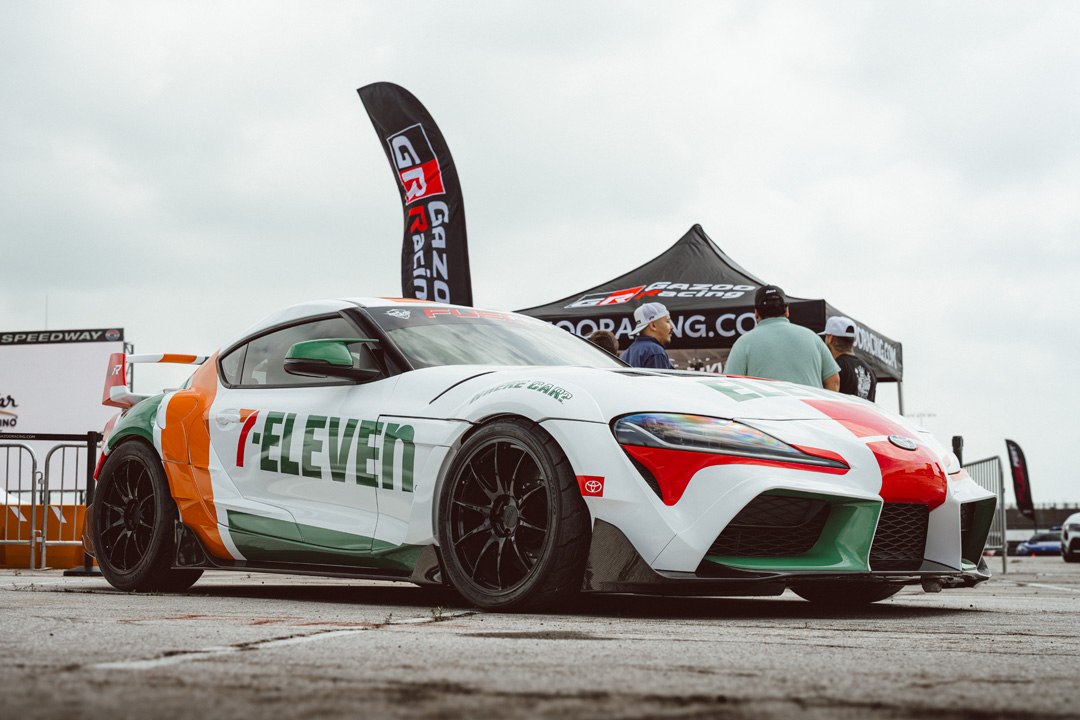 Custom Toyota GR Supra with a 7-Eleven-inspired livery displayed in the FuelFest Dallas-Fort Worth show field.