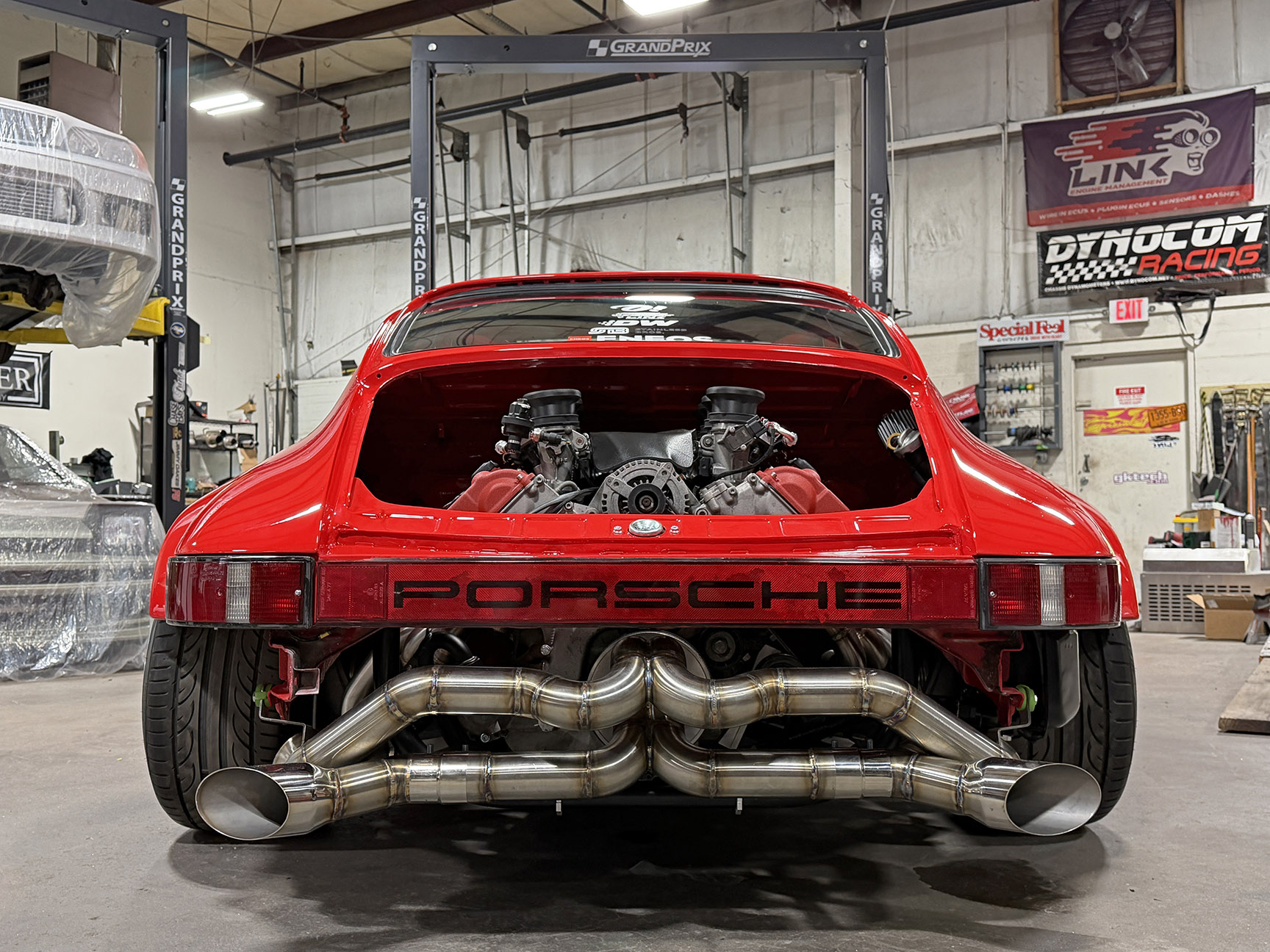 Rear view of Jimmy Oakes’ Porsche 911 SC Porrari showing the exposed Ferrari-built Maserati F136 V8 engine and custom exhaust.