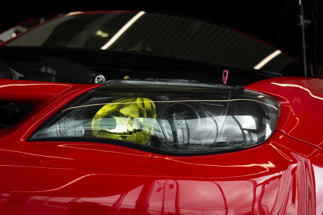 Jon Erickson’s red LS-swapped 2011 Subaru STi with widebody aero and track-focused details.