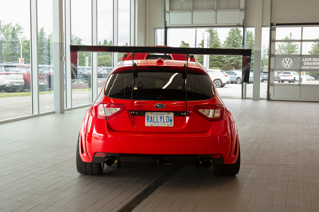 Jon Erickson’s red LS-swapped 2011 Subaru STi with widebody aero and track-focused details.