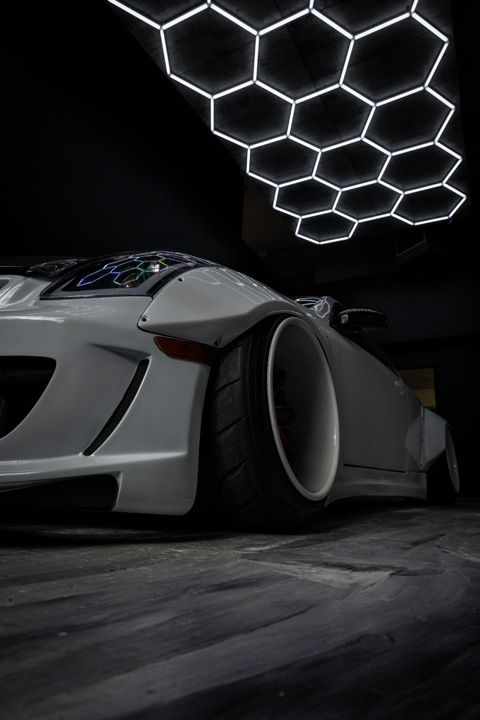 Jordyn Brazeau’s white LS-swapped 2006 Infiniti G35 with widebody aero, pink Weds Kranze Vishnu wheels, and custom carbon-fiber details.