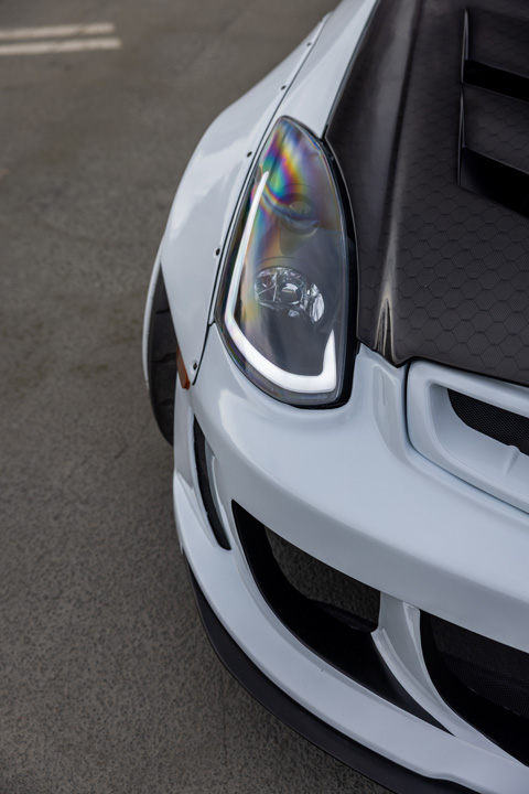 Jordyn Brazeau’s white LS-swapped 2006 Infiniti G35 with widebody aero, pink Weds Kranze Vishnu wheels, and custom carbon-fiber details.
