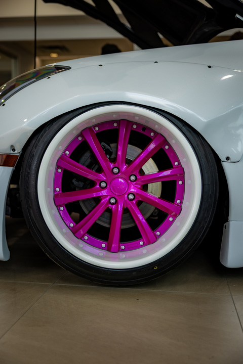 Jordyn Brazeau’s white LS-swapped 2006 Infiniti G35 with widebody aero, pink Weds Kranze Vishnu wheels, and custom carbon-fiber details.