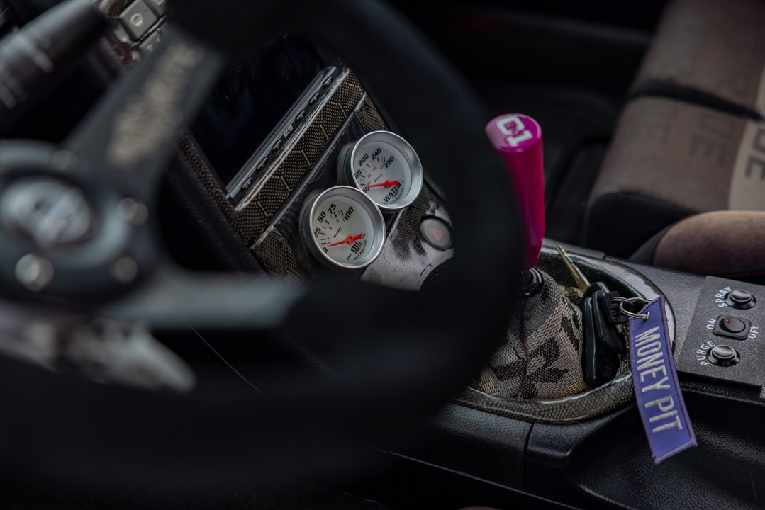 Jordyn Brazeau’s white LS-swapped 2006 Infiniti G35 with widebody aero, pink Weds Kranze Vishnu wheels, and custom carbon-fiber details.