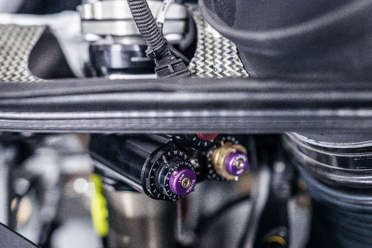 Close-up of KW Racing damper adjustment controls installed on a GT3 race car.