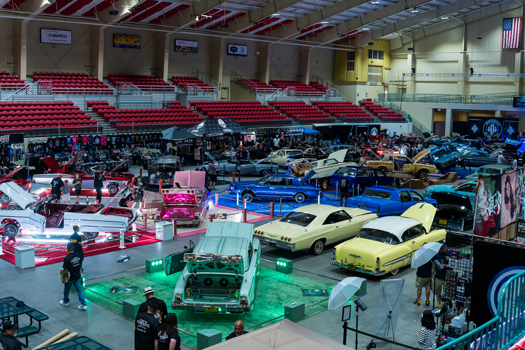 Wide view of custom lowriders on display inside Cabarrus Arena & Events Center during Lowrider Super Show Charlotte 2026.