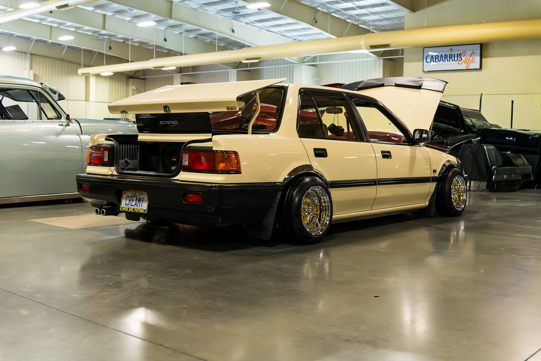 Cream Honda Civic lowrider with wire wheels and open trunk on display at Lowrider Super Show Charlotte 2026.