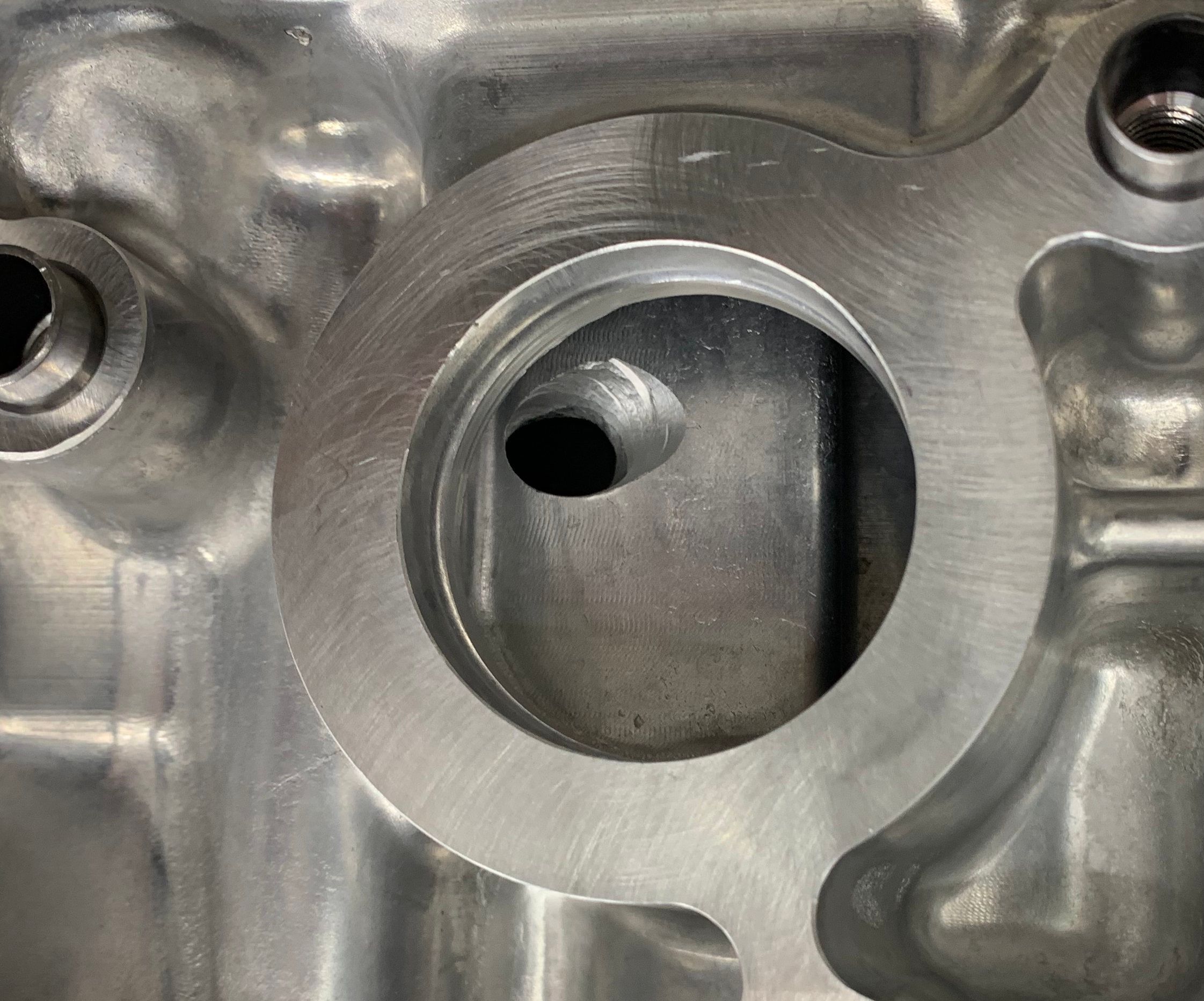 Close-up of the HKS G16E closed-deck short block showing machined water jacket passages for optimized cooling flow.