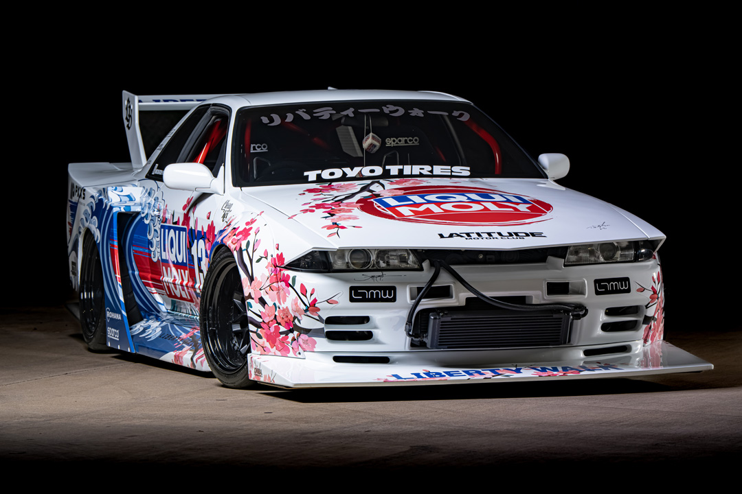 Osmond Seangsuwan’s 1990 Nissan Skyline GT-R with Liberty Walk LB-Kaido widebody aero, LIQUI MOLY livery, Rohana wheels, Toyo tires, RB26 power, carbon interior, and Japanese-inspired artwork.