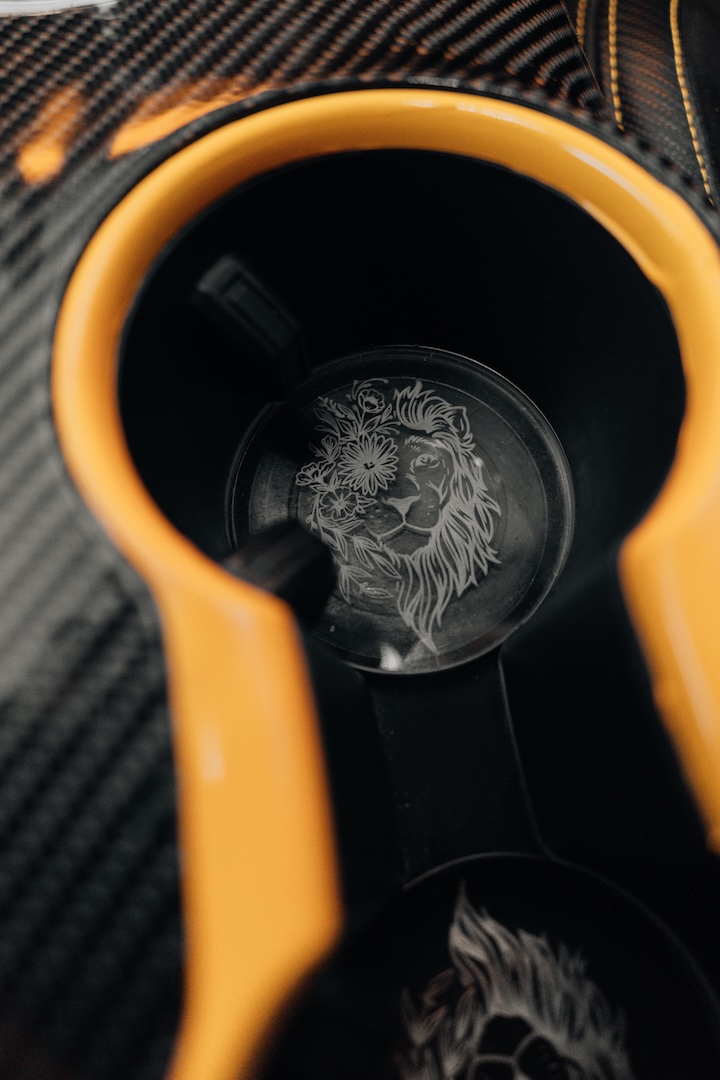 Mussi Hussain’s Cyber Orange 2022 Ford Mustang GT with Robot Craftsman widebody aero, Air Lift suspension, Work Gnosis wheels, custom lighting, carbon-fiber details, and reworked interior and trunk setup.