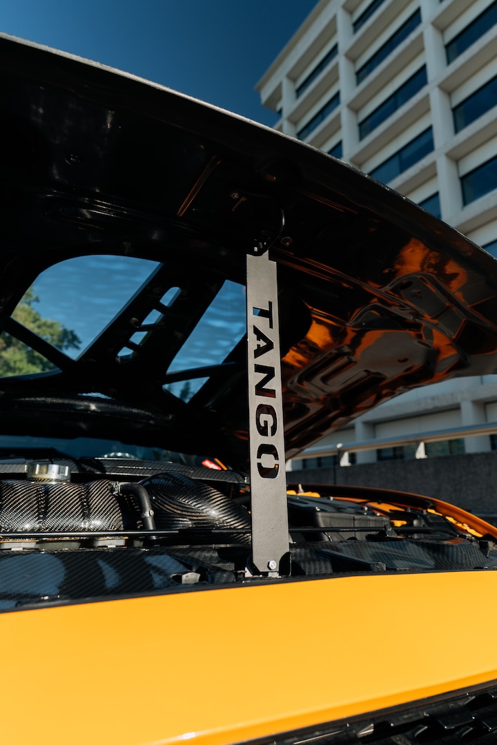 Mussi Hussain’s Cyber Orange 2022 Ford Mustang GT with Robot Craftsman widebody aero, Air Lift suspension, Work Gnosis wheels, custom lighting, carbon-fiber details, and reworked interior and trunk setup.
