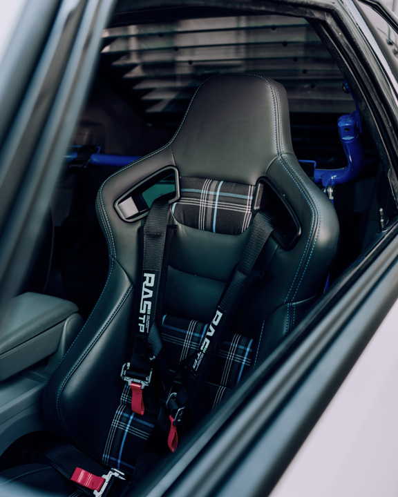 Regan McLaughlin’s 1988 Ford Mustang GT TimeFox with custom multi-tone paint, Ford Barra turbo swap, wide fiberglass fenders, retro Foxbody styling, HaloBLK wheel covers, custom interior, and nostalgic audio details.