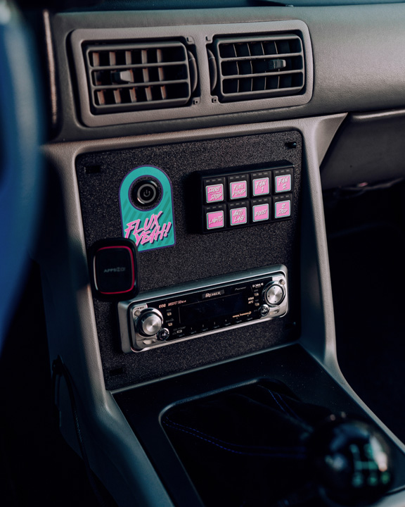 Regan McLaughlin’s 1988 Ford Mustang GT TimeFox with custom multi-tone paint, Ford Barra turbo swap, wide fiberglass fenders, retro Foxbody styling, HaloBLK wheel covers, custom interior, and nostalgic audio details.