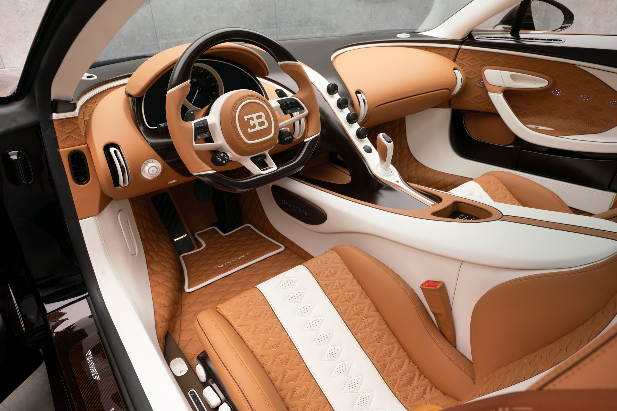 MANSORY Vivere Bugatti-based one-off interior with brown and white leather upholstery, quilted door panels, carbon-fiber trim, and custom MANSORY detailing.
