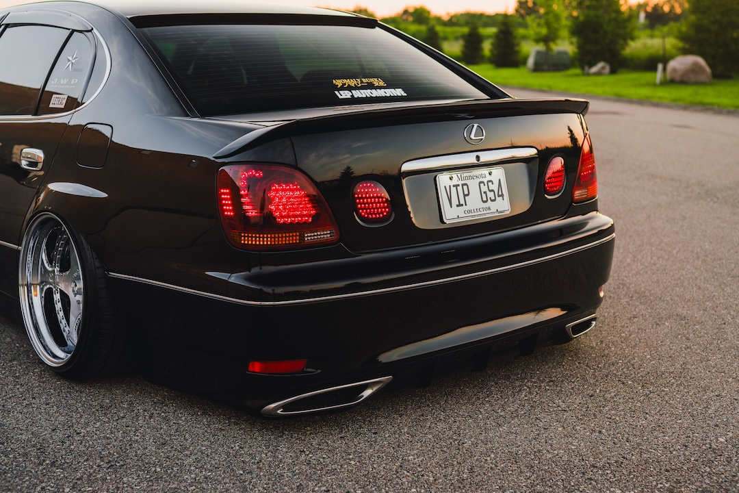 Rear detail of Kyle Harty’s 1999 Lexus GS 400 showing its fourth-generation GS rear bumper merge, Junction Produce spoilers, and dancing LED taillights.