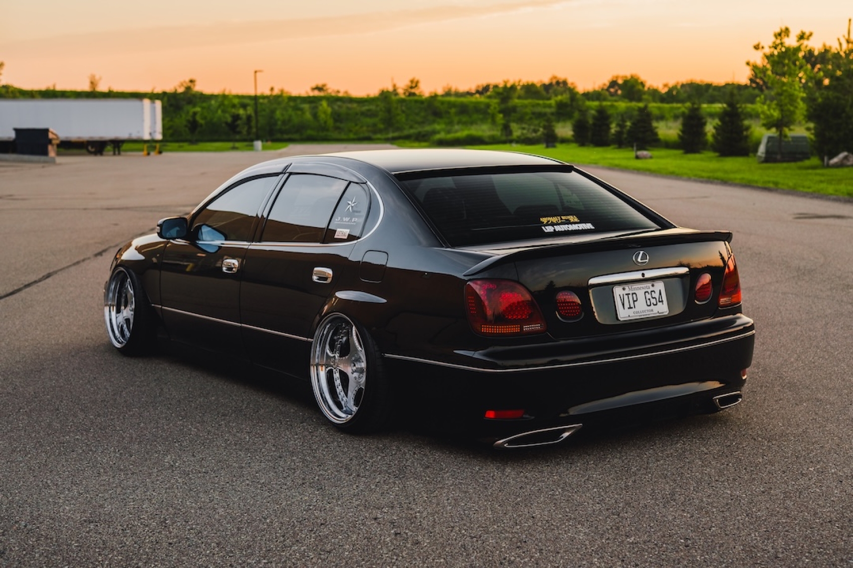 Rear three-quarter view of Kyle Harty’s 1999 Lexus GS 400 showing its widened metal fenders, Luxury Abstract x Junction Produce Scara wheels, and VIP styling.