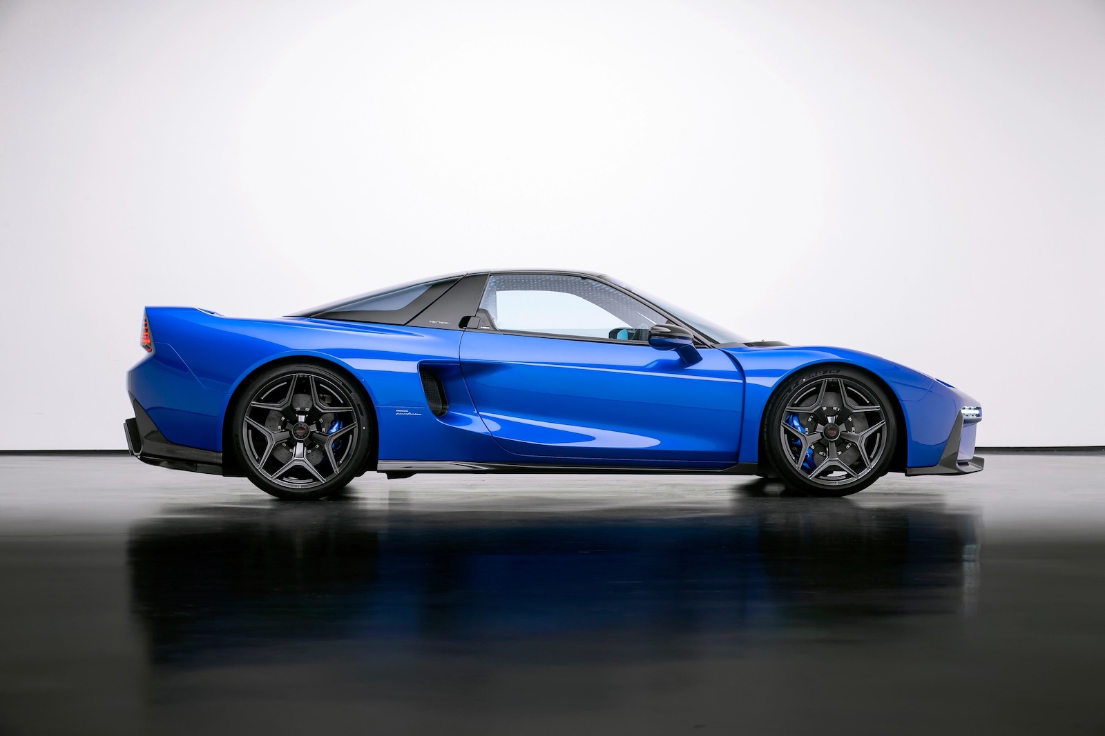 Side profile of the blue JAS Tensei Honda NSX restomod, showcasing its carbon-fibre bodywork, side air intake, forged wheels and Brembo brakes.