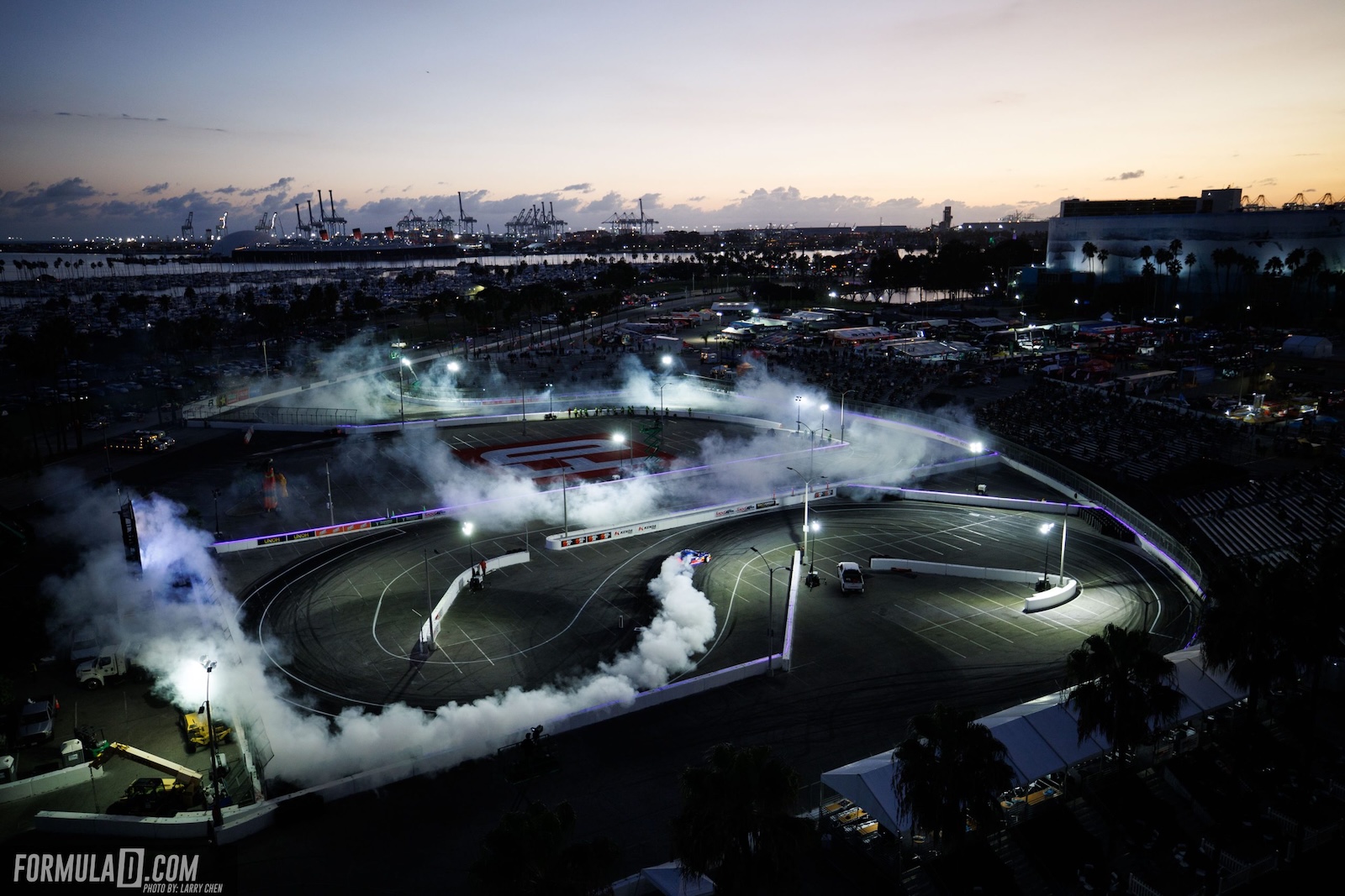 Aerial view of the Formula Drift Long Beach circuit at dusk, with tire smoke covering the track during the 2026 PRO Championship season finale.